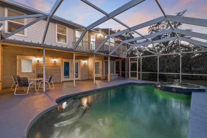 Spacious Screened-in lanai featuring a heated saltwater pool and spa, and out door shower.