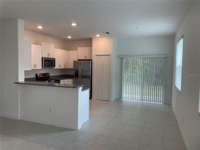 Breakfast bar, sliders leading to covered/screened porch