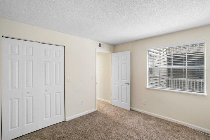 Guest bedroom has double closet with light.