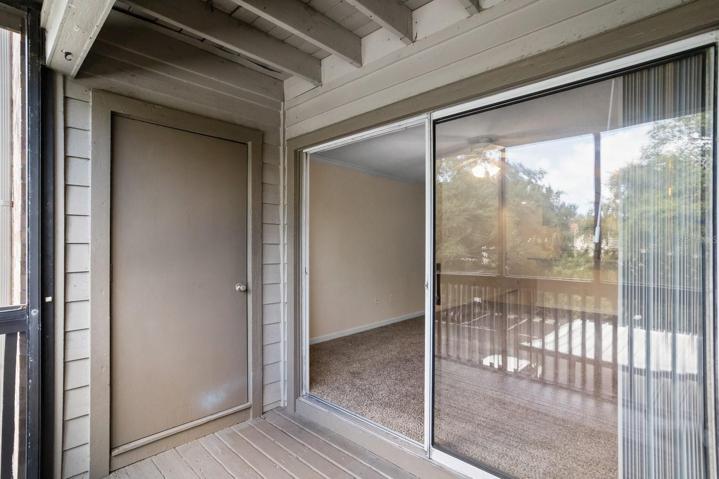 Balcony off living room has storage room.