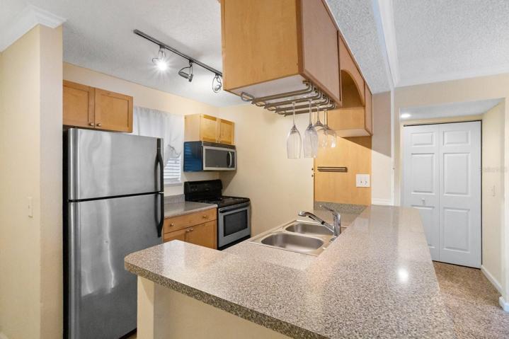 Kitchen has granite counters and stainless appliances.