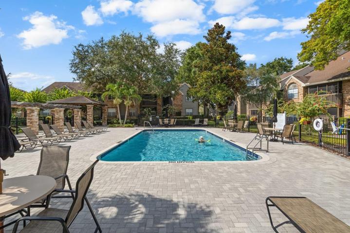 Lots of chaise lounges, tables, chairs and umbrellas.