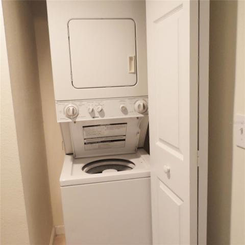 Stackable washer & dryer in hall closet.