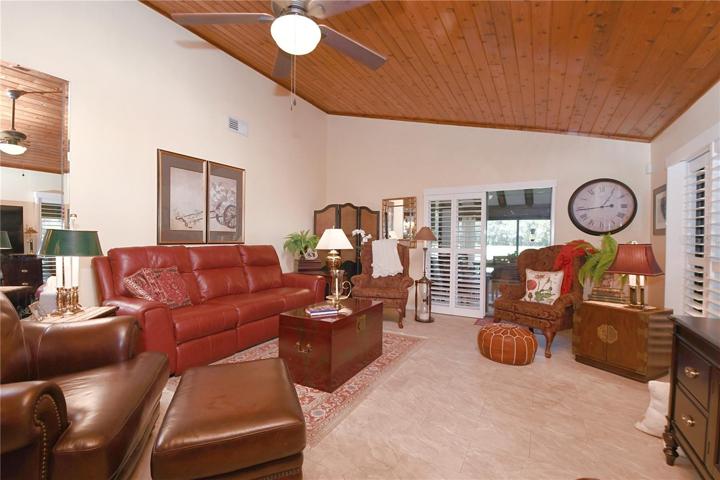 The living room features a vaulted ceiling and ceiling fan.