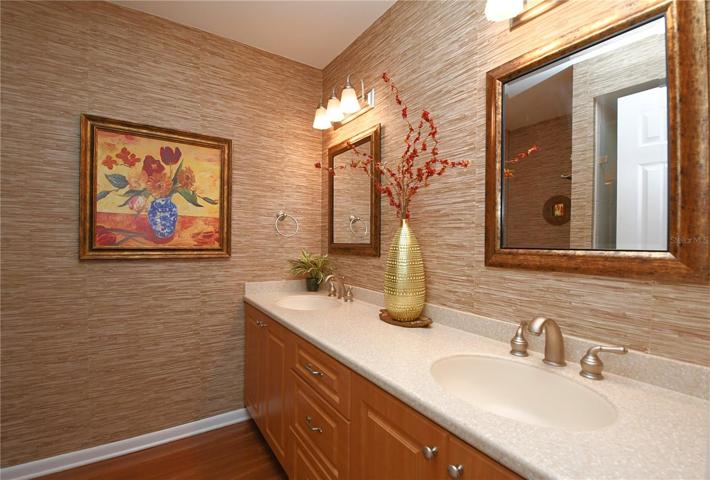 The master ensuite features dual sinks in a mirrored vanity with storage.