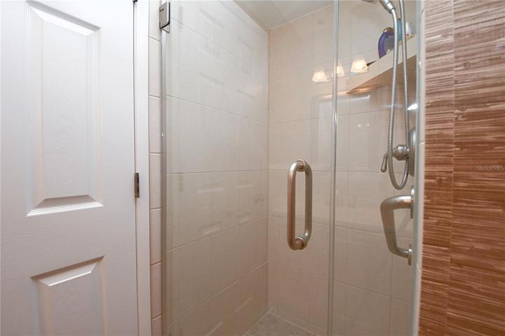 The master ensuite features a glass encased walk in shower.