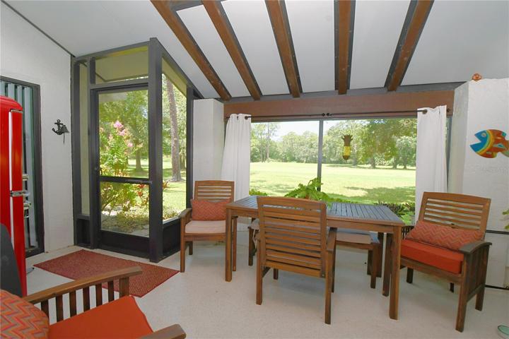 This screened in porch has a birds eye view of the 14th fairway.