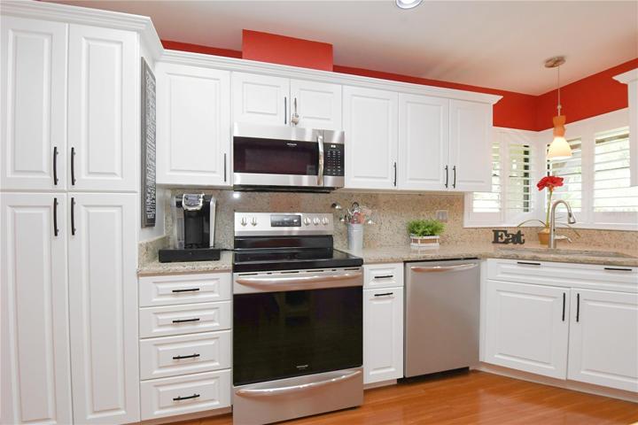 Contemporary design elements like a deep under-mount stainless steel sink, and granite counters with complimentary backsplash.