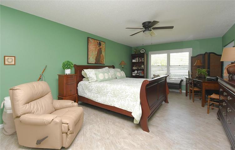 The master bedroom features ceramic tile flooring, an ensuite bathroom, and a ceiling fan.