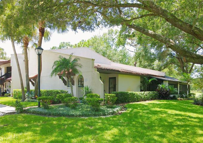 Set against the backdrop of the 14th fairway on the Tarpon Woods Golf Course, this 2-bedroom, 2-bath corner condo unit is a haven of tranquility surrounded by a canopy of oak trees and lush landscaping.