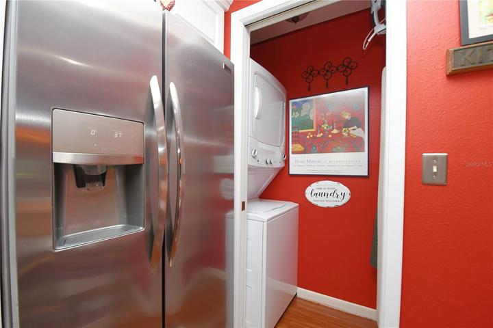 The kitchen features a Frigidaire stainless steel French door refrigerator with an ice maker and water dispenser.