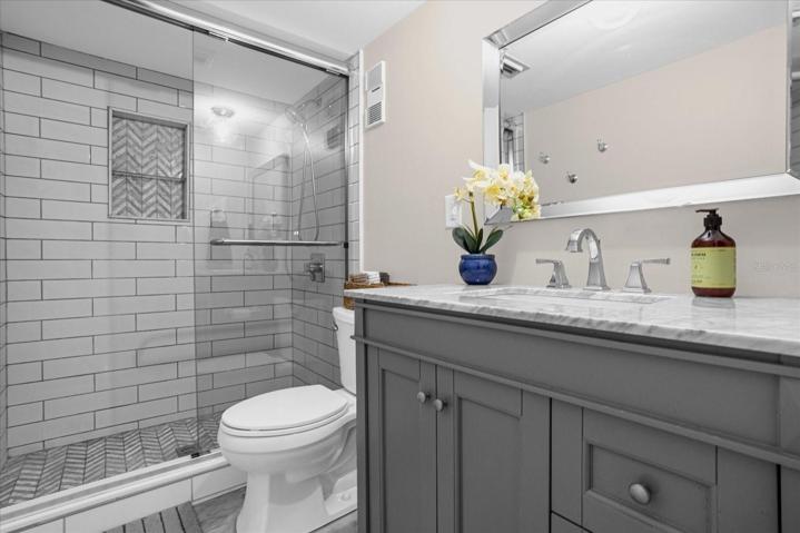 Master Bathroom- Marble tile floors and subway tile, beautiful vanity with marble top. Pocket door!!