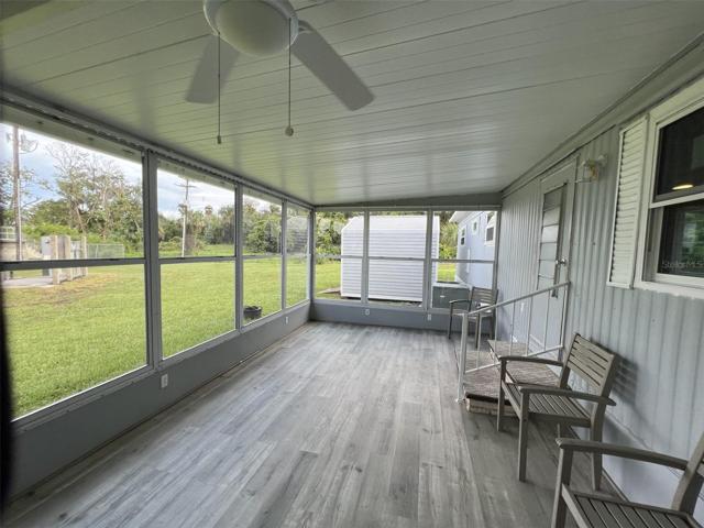 Huge Glassed in Florida Room with central AC.  Faces the lake.  Brand new windows and floor!