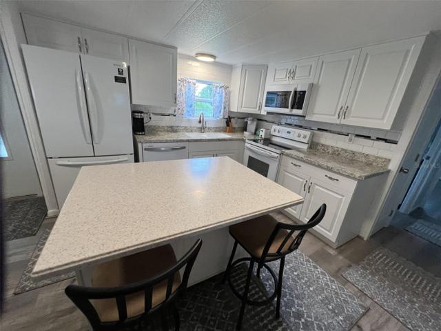 New island was added to the kitchen.  Creates an eat in area.