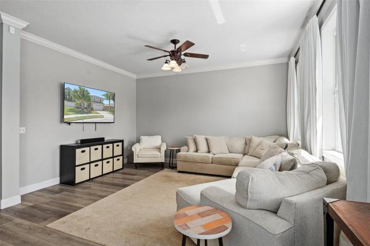 Family Room with Crown Molding and NEW Luxury Flooring