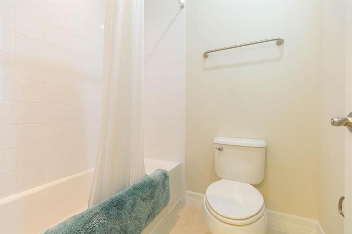 secondary bathroom upstairs with split vanity and tub/shower/toilet