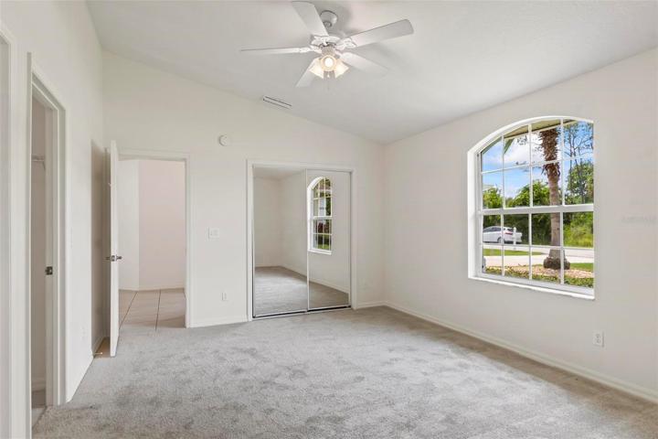 Private primary bedroom with vaulted ceilings