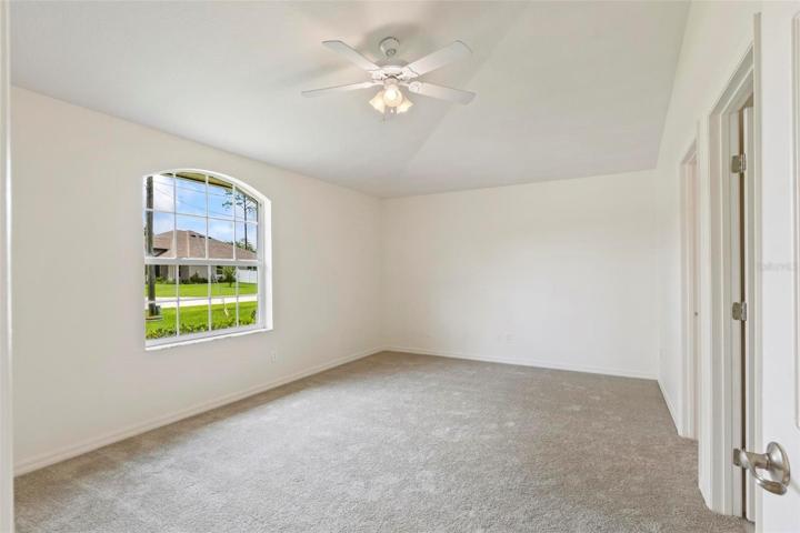 Private primary bedroom with vaulted ceilings
