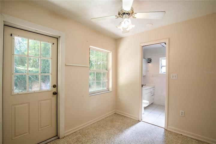 Dining Room with Exterior Door to Backyard and Bathroom #2 access