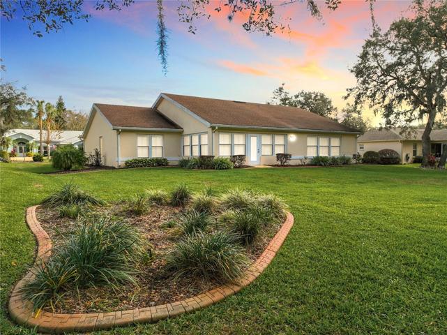 Rear view of home.  New double pane windows throughout the home with plantation shutters.