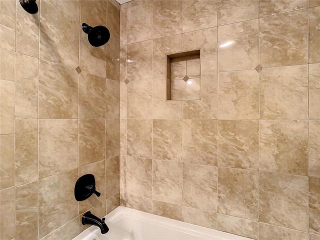 Remodeled tub/shower combination in the guest bathroom.