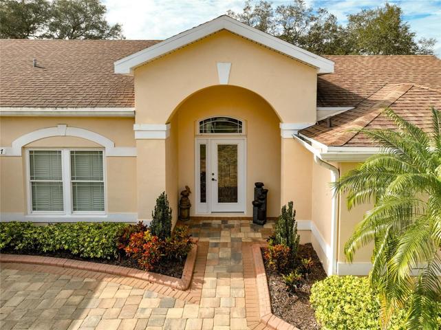 Paver driveway and walkway, side entry garage and mature landscaping.