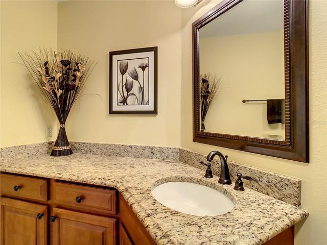 Guest bath has been remodeled with granite counter top, tall vanity, and tub/shower combination.