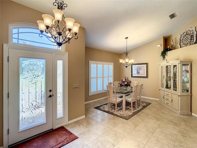 The beautiful beveled front entry door with transom window and side light panel allows natural light to filter into the home.