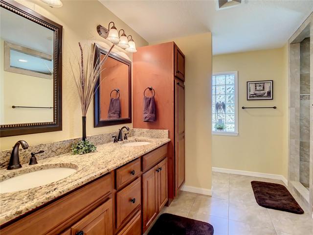 Remodeled, luxury bathroom with tall vanity, granite counter top with his and her sinks.