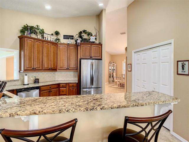 Breakfast bar area with large pantry showing on the right side of the picture.