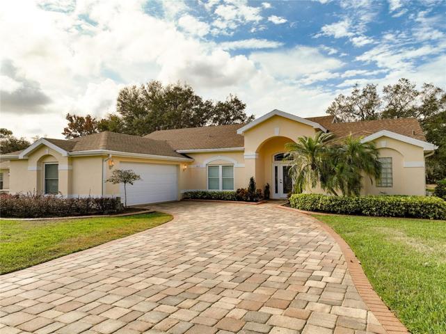 Driving up to the home the curb appeal begins with the paver driveway, side entry garage and mature landscaping.