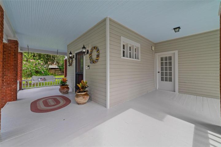 The exterior of this home showcases its timeless charm with a PARTIAL WRAP-AROUND PORCH that beckons you to sit back and relax as you enjoy the beauty of the surrounding landscape!