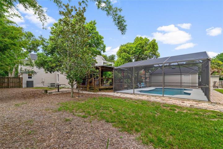 Outside of the pool is a sprawling backyard!