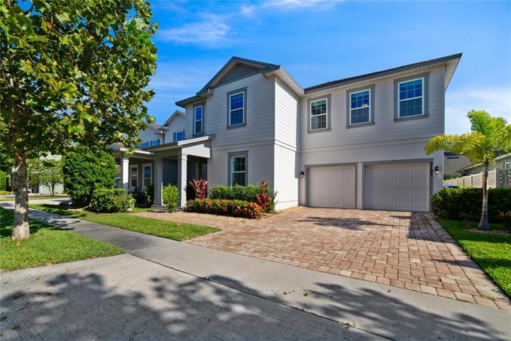 **SHOWS LIKE A MODEL HOME** Perfectly situated in the highly sought-after Latham Park community of Winter Garden with a POND VIEW, this spacious home was BUILT IN 2019 and delivers a bright open concept with a TWO-STORY LIVING ROOM!