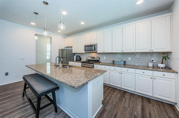 Modern Upscale Kitchen with Accent Lighting and Attractive Backsplash