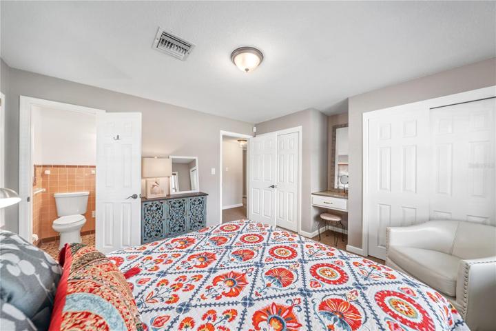 Primary with view to en-suite.  Two closets plus built in desk