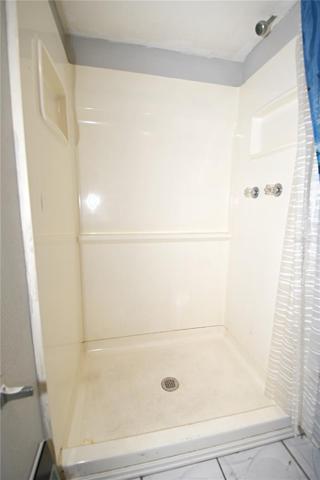 The en-suite bathroom features a walk-in shower, adding to the luxurious feel of the space.