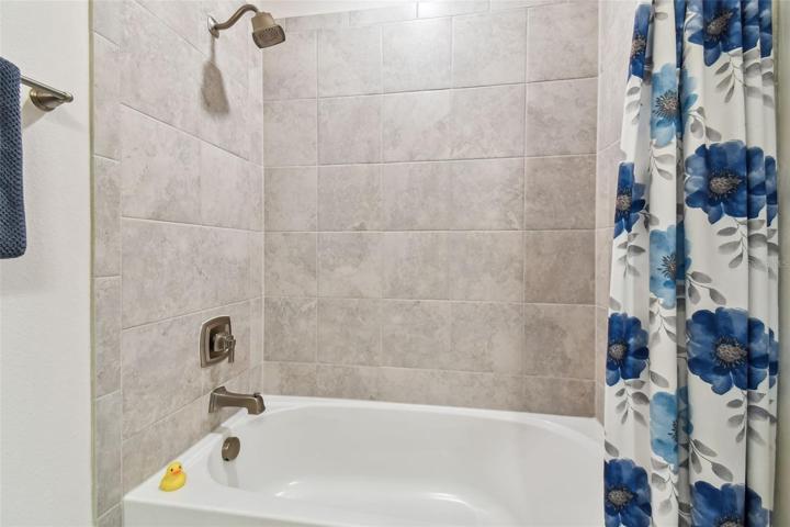 Tub/Shower combo in mini suite bath.