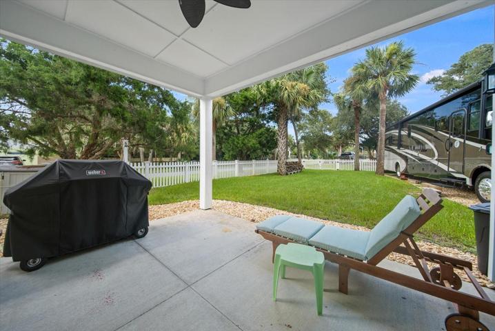 Lower-level covered patio within fenced yard
