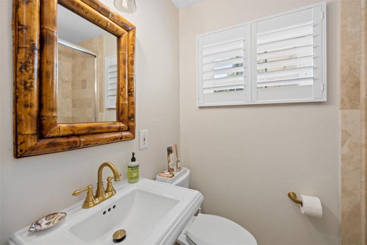 Hall Bath with Travertine tile shower with glass doors
