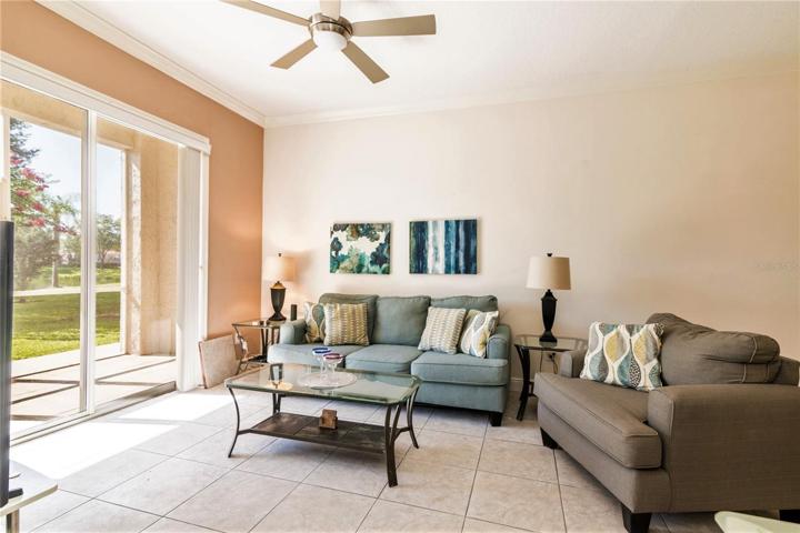 Living Room with sliding glass doors to lanai and pond.