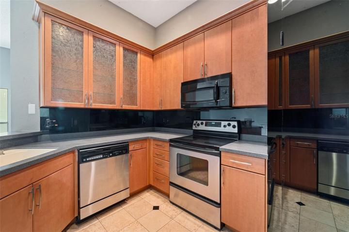 Wood cabinets and sandstone(?) countertops