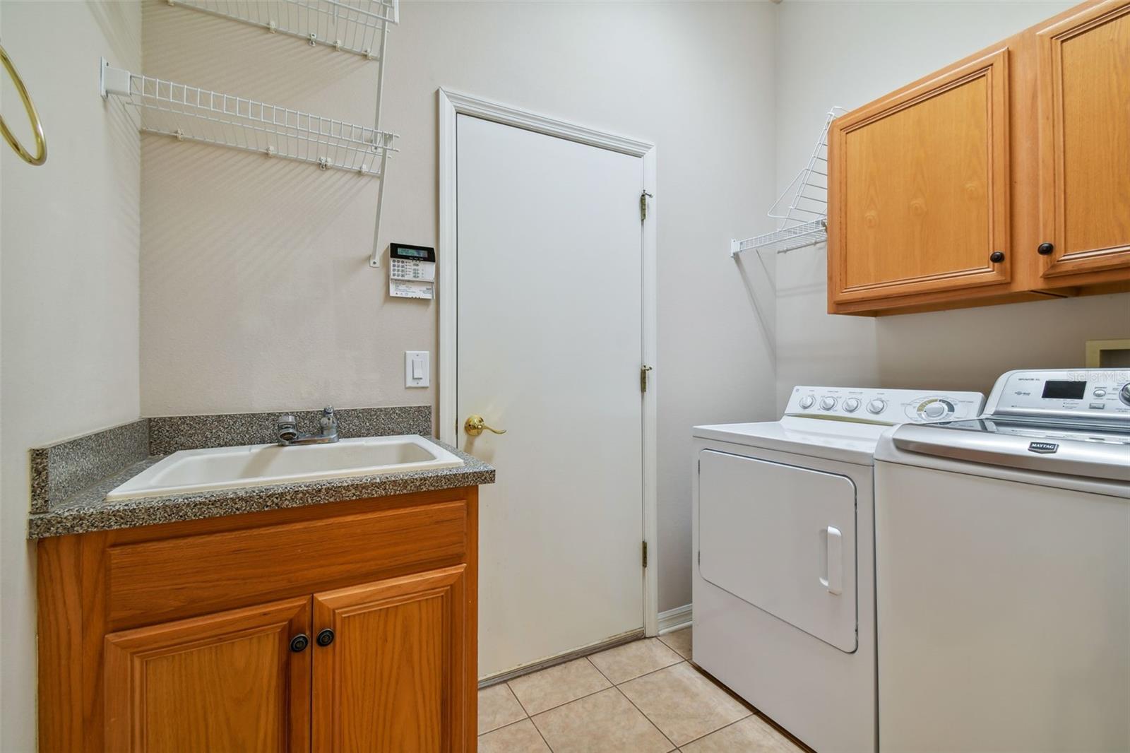 Washer and dryer stay with the sale and enjoy the utility sink and additional cabinets