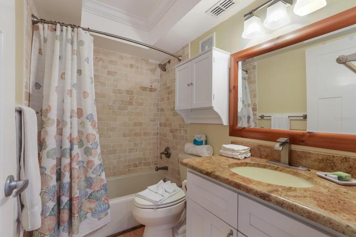 Bathroom #1 w/ tub/shower combo and granite counters