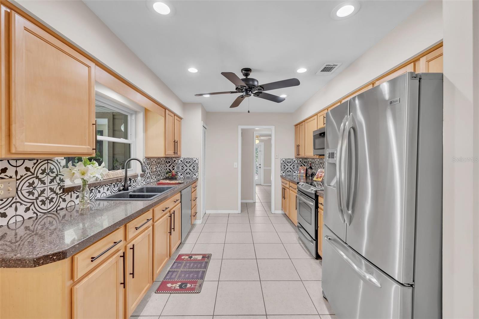 Kitchen has been remodeled with Silestone counters as well as newer Stainless appliances, new recessed lights and a tile backsplash!