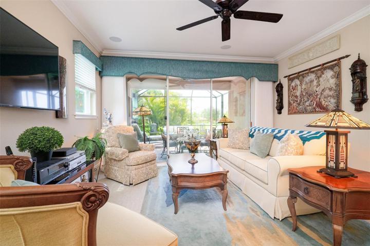 Living room with triple slider to extended lanai