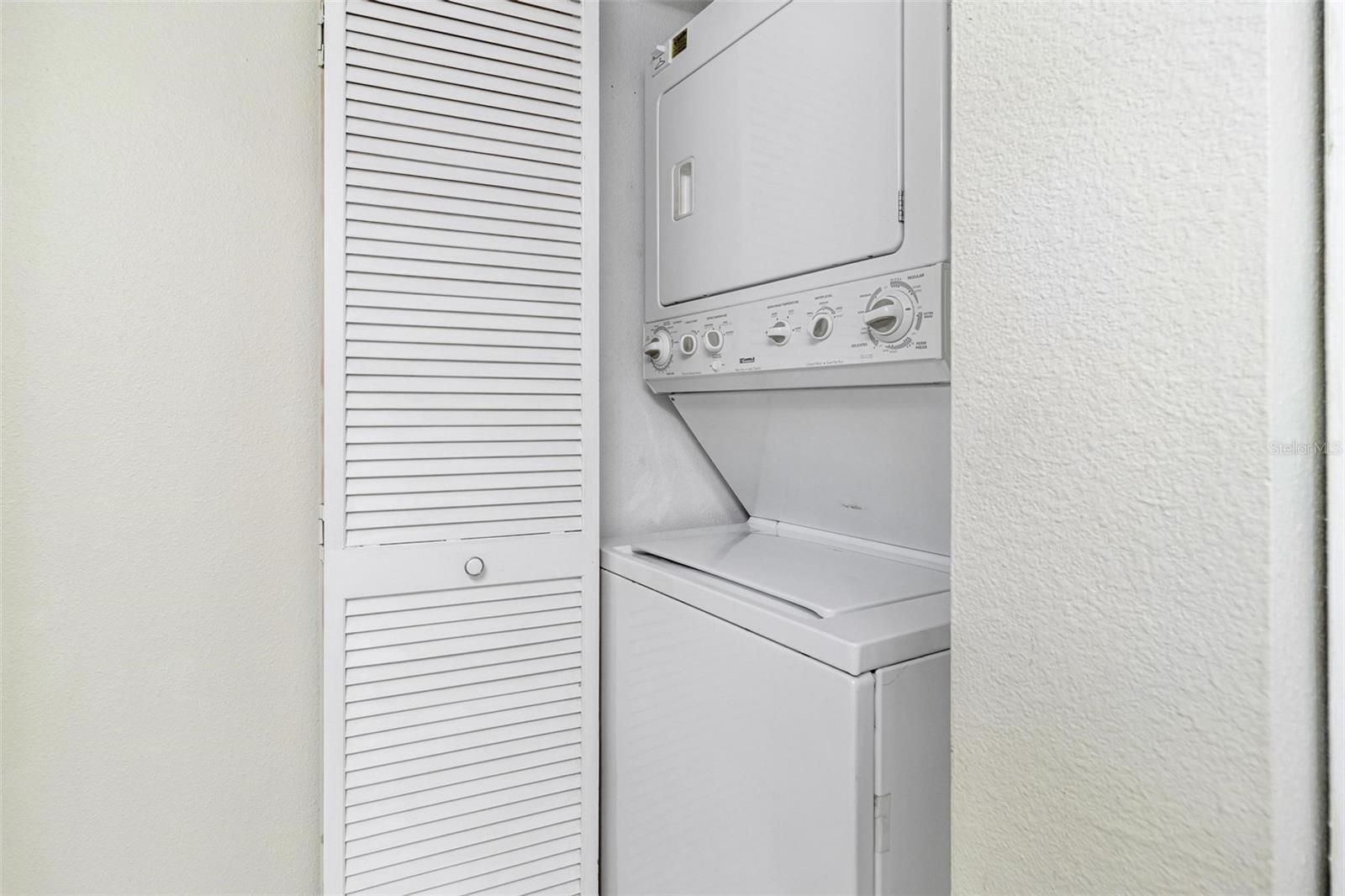 Washer and dryer closet in guest bathroom