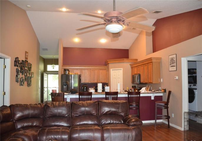 Kitchen View From Great Room/Family Room Plant Shelves And Crown Molding Above The Cabinets