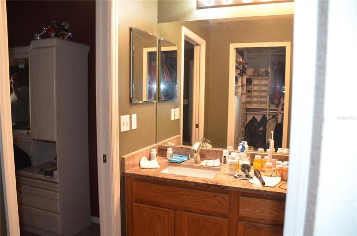 Primary Bathroom Has Oak Cabinets, Double Vanity Sinks And Granite Counters