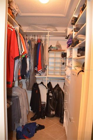 Primary Bedroom Suite Has Walk In Closet With Custom Shelves